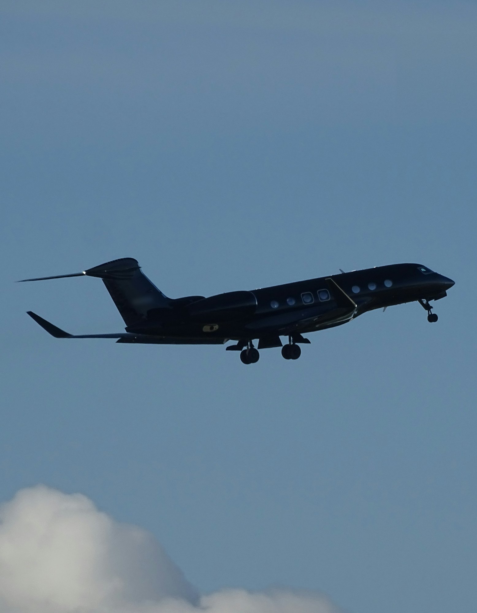 A Gulfstream G650ER business jet climbing into a blue sky